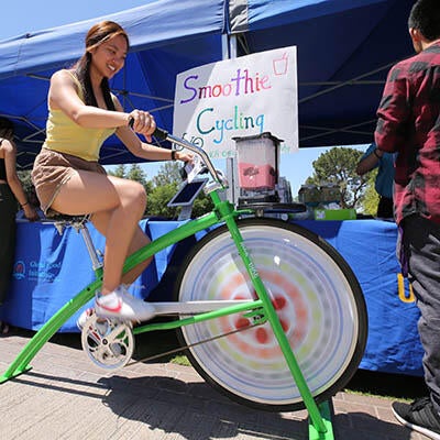 A woman riding a custom-built stationary bike.